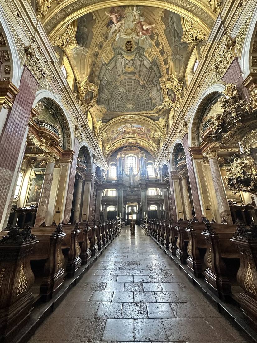 Gilded baroque interior of the Jesuitenkirche with marbled columns and galleried oratories