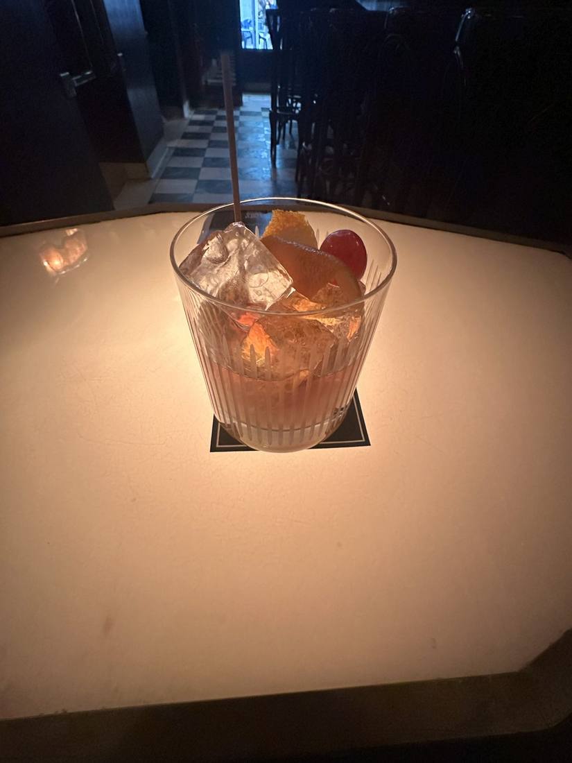 Old Fashioned on a coaster at Loos American Bar with checkered floor visible