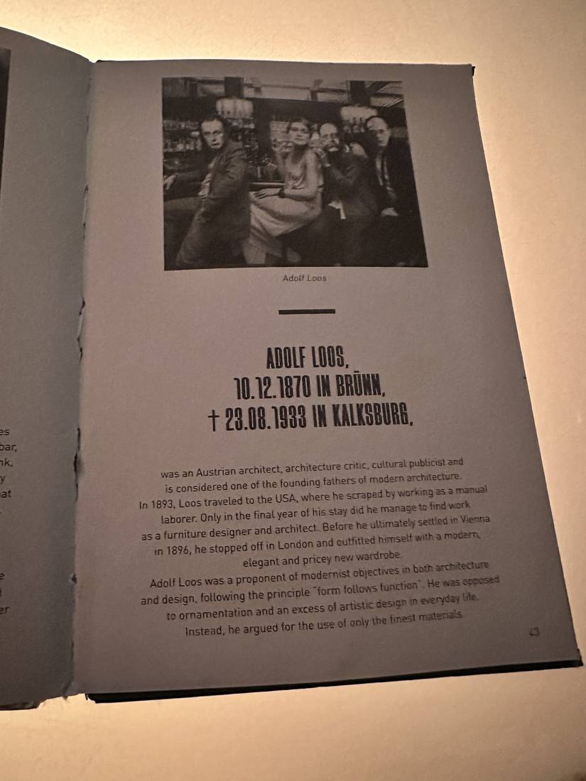 Open monograph on Adolf Loos on the bar table