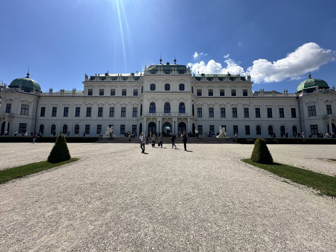 Upper Belvedere palace front with cypress trees in cone shapes