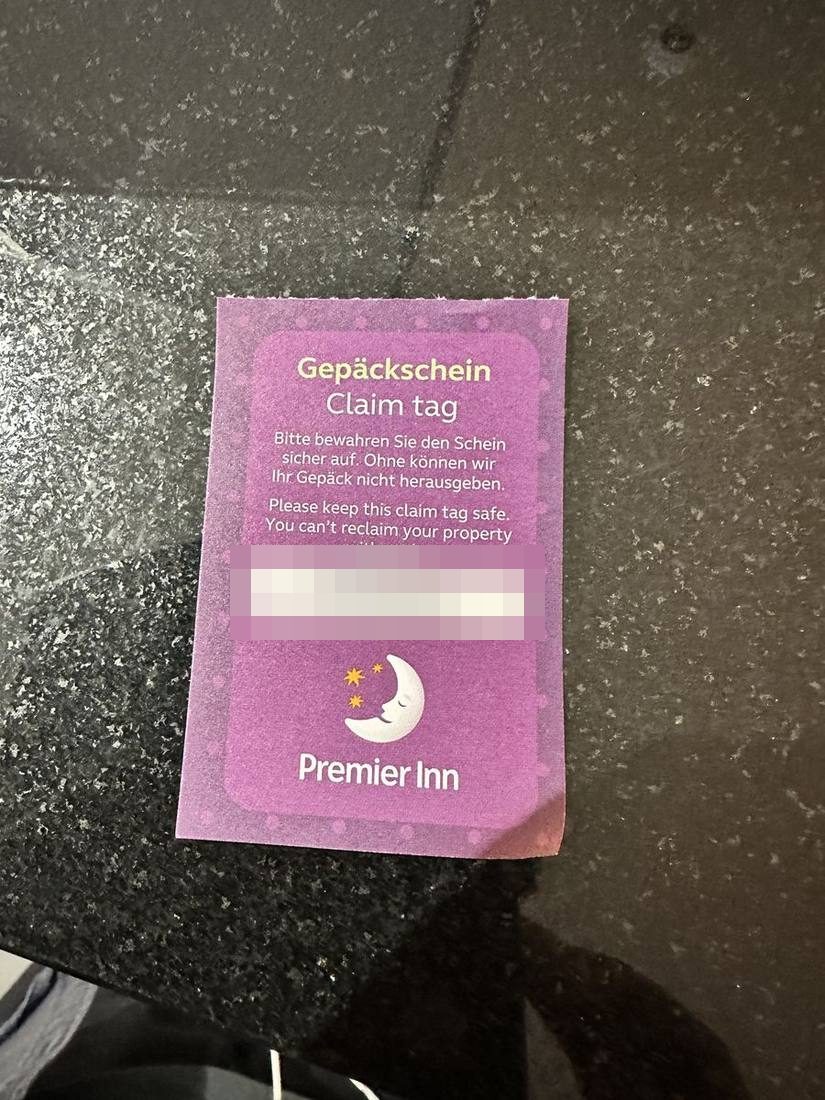 Premier Inn luggage claim tag with number redacted