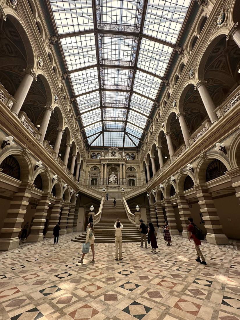 Glass-roofed atrium of Palace of Justice with grand marble staircase